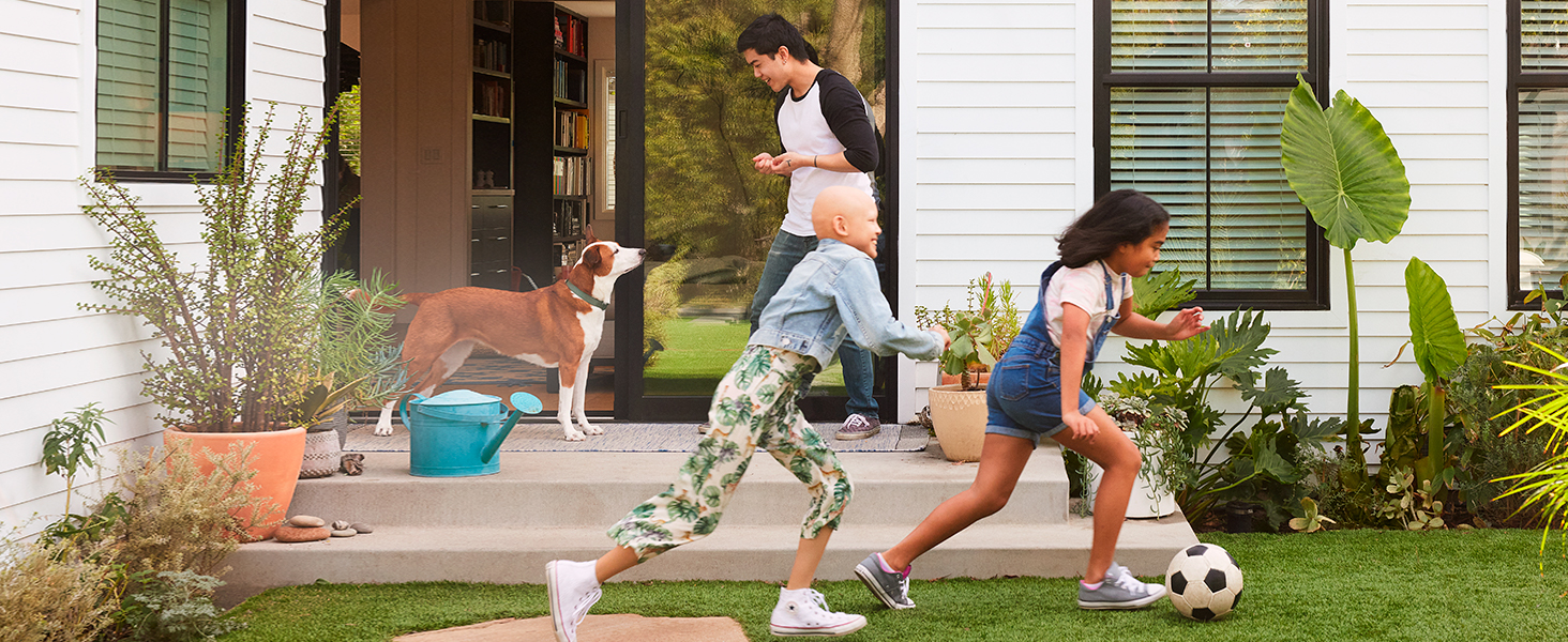 Children running around their backyard